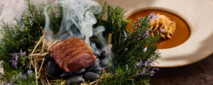 Meat cooking over hot stones