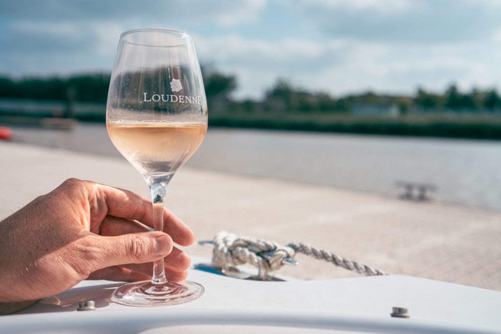 Glass of rose wine on a boat of Chateau Loudenne